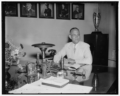 New Chief of U.S.N. navigation assumes post. Washington, D.C., June 11. Rear Admiral J.O. Richardson, who today succeed Rear Admiral Adolphus Andrews as Chief of the Navy Bureau of Navigation, pictured at his desk shortly after taking the oath, 6/11/38