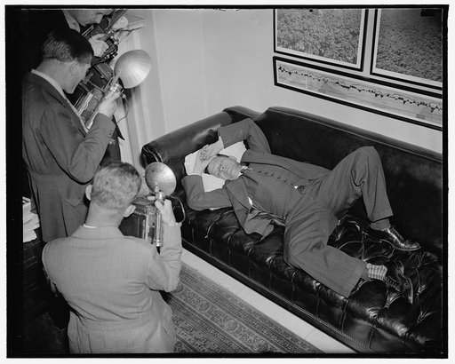 Exhausted after wage-hour fight in senate. Washington, D.C., June 13. Senator Allen Ellender Democrat of Louisana and onetime Lieutenant of the late Huey Long, is snapped by news cameramen as he rests in his office after leading the victorious fight for the compromise in the wage-hour bill. The comp