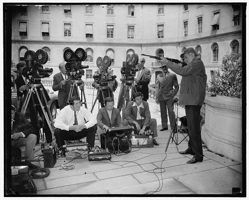 Texas senator tries out "shooting irons" for news cameramen. Washington, D.C., June 14. Looking forward to a hunting trip in his native state as soon as Congress adjourns this week, Senator Tom Connally, democrat of Texas, checked his guns and did a little fancy shooting for the benefit of the camer