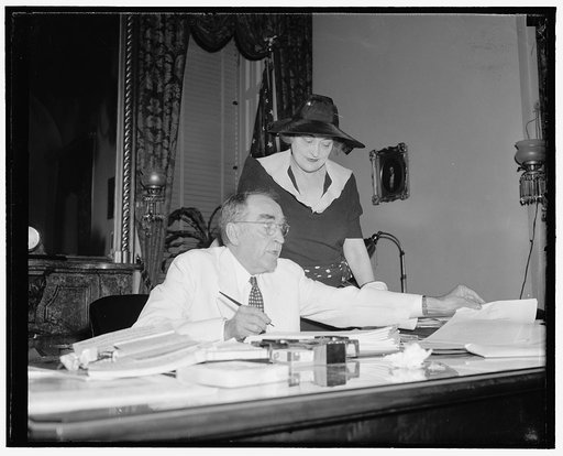 Speaker signs last minute bills. Washington, D.C., June 15. With Mrs. Bankhead looking on, Speaker of the House William B. Bankhead is pictured signing last-minute bills as the House neared adjournment today, 6/15/38