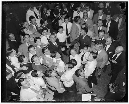 Speaker Bankhead bids goodbye to colleagues and pages as 75th congress adjourns. Washington, D.C., June 16. The house floor was a bedlam as Speaker Bankhead (center) endeavored to shake the hands of all of his colleagues and the page boys when the 75th congress adjourned, 6/16/38