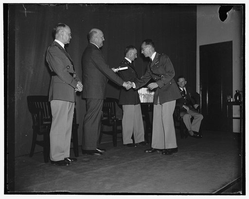 Diplomas conferred on War College graduates. Washington, D.C., June 22. Today was graduation day at the Army War College at Fort Humphrey's here. Assistant Secretary of War Louis Johnson is pictured presenting a diploma to Maj. Theodore L. Futch, one of hundred U.S. Army Officers to graduate with th