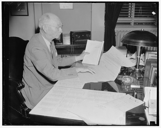 Long time between these bills. Washington, D.C., June 29. Clerk of the House during the Wilson administration and now holding the same job under the present Roosevelt administration, South Trimble compares his signature on the recently passed tax bill with that of John Beckley, first Clerk of the Ho