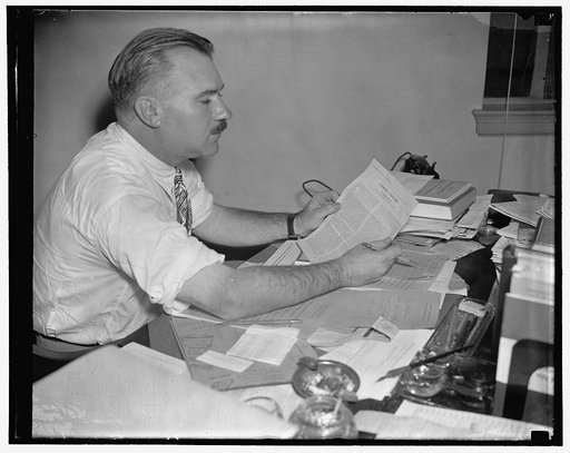 G.O.P. Tun Thumper inspects brain child. Washington, D.C., June 29. Franklyn Waltman, new publicity director of the Republican National committee, inspects his initial release of "Looking Forward." The release is almost identical, as to make-up and type-face, as that put out by Charles Michaelson, D