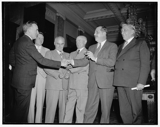 Members congratulate chairman of congressional monopoly committee. Washington, D.C., July 1. Senator Joseph C. O'Mahoney (left) of Wyoming, named Chairman of the Congressional Monopoly Committee at their first meeting today, receives the congratulations of other members of the investigating group. O