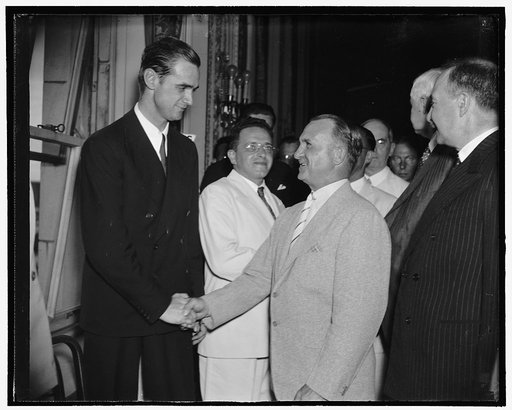 Chief of Army Air Corps congratulates Howard Hughes. Washington, D.C., July 21. Gen. Oscar Westover, Chief of the Army Air Corps, right; Congratulates Howard on his round the world flight, Hughes was a visitor in Washington today, and the chief of the Air Corps was one of the first to congratulate h