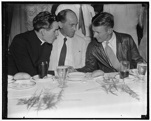 Irish get together with Corrigan Washington, D.C., Aug. 10. Doug "Wrong Way" Corrigan, honor guest of the Ancient Order of the Hibernians at the Willard Hotel, sits down to luncheon with Rev. Sheehan, (left) and Charge D'Affairs of the Irish Legation Robert Patrick Brennan, 8/10/38
