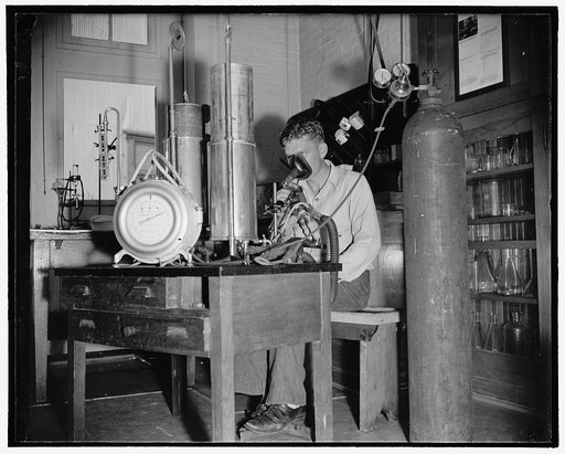 Add record depth reached by Navy divers. E.B. Crosby, Boatswain's Mate, 1st Class, U.S.N., rebreathing into a special apparatus which measures the amount of helium gas absorbed by body after a dive into the tank at Washington Navy Yard,. 8/9/38