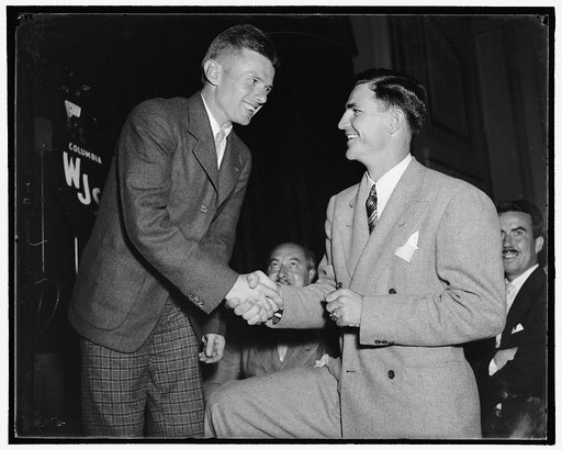 Ace passer and wrong way flyer meet. Washington, D.C., Aug. 11. Champions in their fields. Doug "Wrong Way" Corrigan, who was warmly welcomed in the Nation's Capitol, greets Sammy Baugh, Ace Passer of the Washington Redskins Professional Football team, at a reception at the National Press Club, 8/11