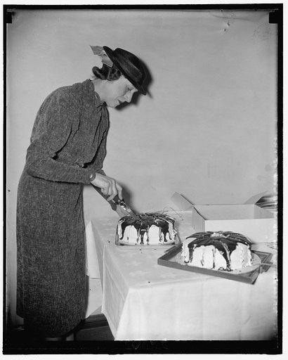 Mrs. William James Burlow, wife of Senator from S. Dak., preparing cake for Senate Ladies Luncheon Club