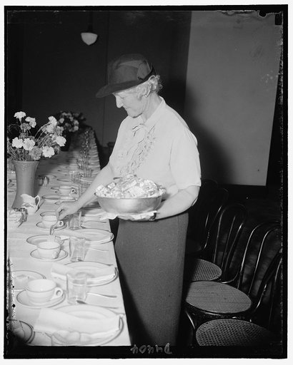Mrs. James F. Byrnes, wife of the Senator from SC., serving butter at the Senate Ladies Luncheon Club in Senate Office Bldg.
