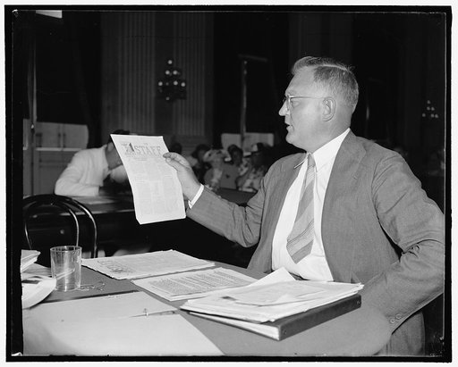 Brooklyn Professor testifies before the House Un-American Committee. Washington, D.C., Aug. 23. Earl A. Martin, Chairman of the Brooklyn [...]Biology Department, shows members of the Dies Un-American Committee, communist propaganda distributed thru the school under the guise of a school pamphlet he 