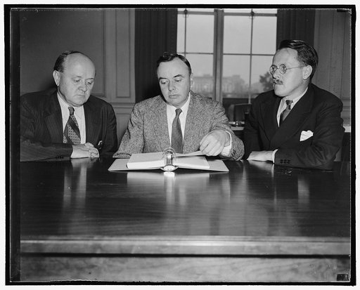 Wage-Hour Administrator and assistants. Washington, D.C., Sept. 14. Probably the busiest government agency in the Capitol these days is The Wage-Hour Administration. The Wage-Hour Administrator, Elmer F. Andrews, is pictured for the first time with the newly appointed assistant administrators, Col. 