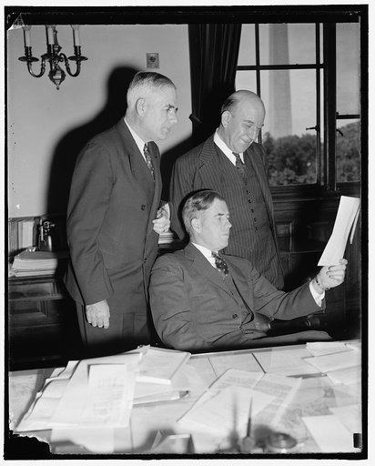 Direct nation's farm policies. Washington, D.C., Sept. 22. The farmers of the Nation look to these men to solve their many problems. Pictured, left to right, are: M.L. Wilson, Undersecretary of Agriculture; Secretary of Agriculture Henry A. Wallace, and H.R. Tolley, A.A.A. Administrator, 9/22/38