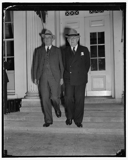 Discuss government reorganization with President Roosevelt. Washington, D.C., Sept. 23. Charles E. Merriam, (left) and Louis Brownlow, members of the President's Reorganization Committee, leaving the White House today after discussing government reorganization with President Roosevelt, 9/23/38