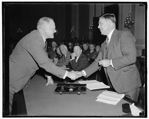 Both sides of the fence. Washington, D.C., Sept. 30. Herbert Enoch's, (left) Chief of Personnel of the Pennsylvania Railroad, greets George M. Harrison, President, Brotherhood of Railway and Steamship Clerks, as both attended the initial hearing of President Roosevelt's emergency fact-finding board 