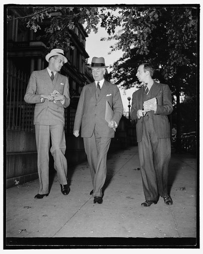 State Secretary pressed for latest news on European situation. Washington, D.C., Sept. 26. Leaving the White House today after listening with President Roosevelt to Hitler's speech, is accompanied to his office by reporters seeking latest news on the European situation, 9/26/38