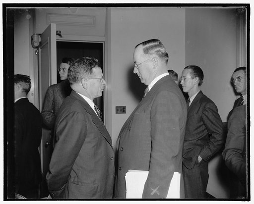 Both sides. Washington, D.C., Oct. 11. Sidney Hillman, President of the Amalgamated Clothing workers, and Donald Nelson, (right) Chairman of the First Industry Committee under the new Wage-Hour Law, chat informally as the waited for the committee to meet today. The committee was meeting to consider 