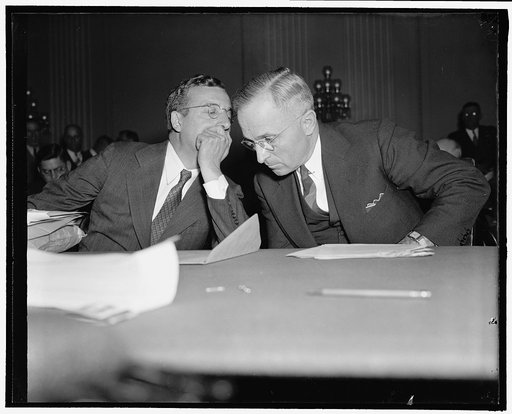 Whispered advice. Washington, D.C., Oct. 14. Senator Harry Truman (right) of Missouri, who today opposed the proposed rail wage cut before the President's fact finding board, gets a bit of last minute information from Max Lowenthal, counsel for the Senate Interstate Commerce Committee. In contending