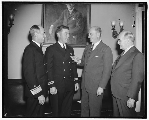 Coast Guard flyer gets distinguished flying cross. Washington, D.C., Oct. 14. In recognition of a flight made 130 miles to sea through fog and rain to rescue a severely injured seaman, whose life was [àed] by prompt hospitalization, Lieut. R.L. [àrke], Coast Guard aviator, was today presented with t