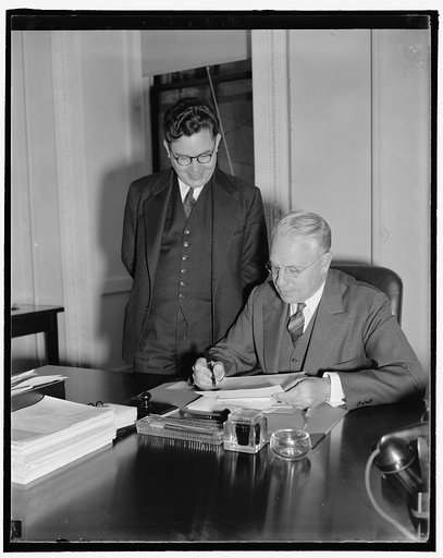 Special to the Monitor. Chief of the Cultural Relations at the State Dept. seated Dr. Ben. Cherrington, with his Asst. Dr. Richard Pattee, standing