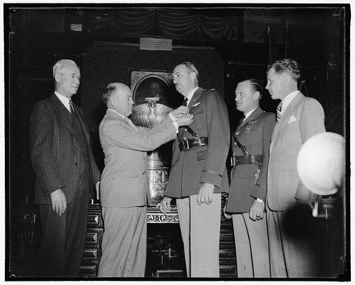 War Secretary presents Army Flyers with Mackay Trophy. Washington, D.C., Oct. 14. As a reward for their development and demonstration of the original automatic landing device for aircraft, Captains Carl J. Crane and George V. Holloman, U.S. Army Air Corps, were today presented with the MacKay trophy