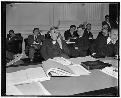 Fact finding board Chairman intent as he hears final argument on wage cut. Washington, D.C., Oct. 17. Chief Justice Walter P. Stacy; chairman of the president's fact finding board, ponders as he listens to final argument by Charles MacKay, counsel for 18 railroad labor organizations, non labor's opp