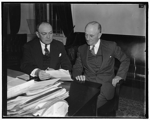 J. Frank Wilson, seated, Chief of US Secret Service, Left, and Joseph Murphy, Asst. Chief, 10/38