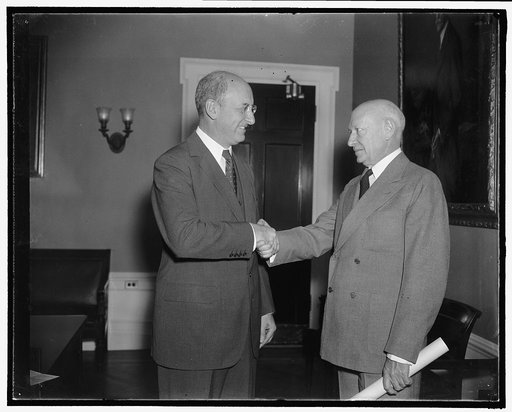 Secretary of Treasury welcomes new Comptroller of the currency. Washington, D.C., Oct. 24. Preston Delano, right, recently named Comptroller of the Currency to succeed J.F.T. O'Connor, is welcomed by Secretary of the Treasury Henry Morgenthau as he assumed his new post today. A native of Phoenix, Mi