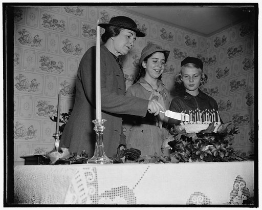 Wife of Agriculture Secretary guest of Secretary. Washington, D.C., Oct. 29. National Girl Scout week was officially opened in Washington today with Mrs. Henry A. Wallace, wife of the Secretary of Agriculture, as guest of honor of the Scouts at the National Girl Scout Little House. She is shown cutt