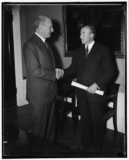 Hanes gets commission as Undersecretary of Treasury. Washington, D.C., Oct. 31. Secretary of Treasury, Henry Morgenthau congratulates John W. Hanes after presenting him the commission as Undersecretary of Treasury. A former member of the S.E.C., Hanes succeeds Roswell Mgill in the Undersecretarial P