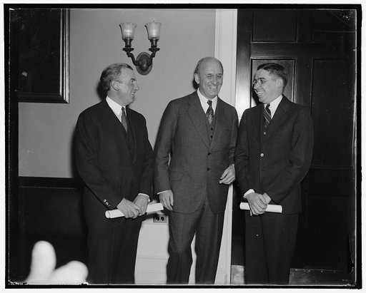 Treasury promotions. Washington, D.C., Oct. 31. John W. Hanes, left, today took the oath as Undersecretary of the Treasury, while Eugene S. Duffield, right, was sworn in as a special assistant to the Secretary. Secretary of Treasury Morgenthau seems happy over the selection of his new assistants. Ha