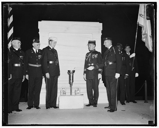 Light symbol of world peace. Washington, D.C., Nov. 4. A torch, symbolic of peace and amity, was lighted last night before the tomb of the unknown soldier at Arlington National Cemetery. After ceremonies conducted by the American Legion, the torch was sent on its way to Paris for observance of Armis