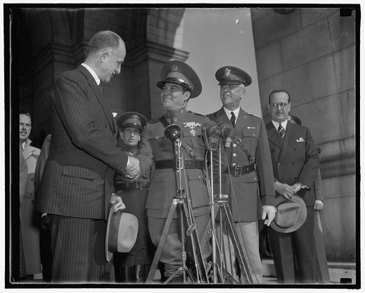 Cuba's Dictator greeted upon arrival. Washington, D.C., Nov. 10. Sumner Wells, The Undersecretary of State, shown shaking hands with Col. Fulgencio Batista as Gen. Malin Craig, the Chief of Staff of the U.S. Army looks on, 11/10/38
