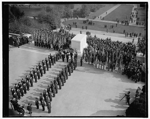 American Legion pays tribute to one of their buddies. Washington, D.C., Nov. 11. Scene at the Tomb of the Unknown Soldier today as the American Legion paid tribute to one of there buddies in solemn Armistice Day ceremonies. Stephen Chadwich, National Commander, is pictured placing the wreath, 11/11/