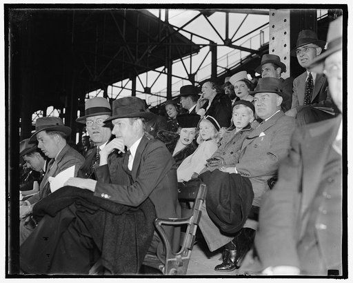 Woodrings see Kansas G.W.U. game. Washington, D.C., Nov. 12. Secretary of War and Mrs. Harry H. Woodring with their two children; Melissa and Marcus Coolidge were spectators at today's gridiron tilt between Kansas and George Washington Universities, 11/12/38