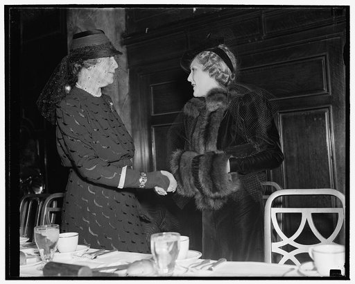 Wife of Secretary of State greets Mary Pickford as both are guests of newspaper women. Washington, D.C., Nov. 15. Mrs. Cordell Hull, wife of the Secretary of State, greets Mary Pickford, America's movie sweetheart for more than a decade, as both were honor guests of the Women's National Press Club a