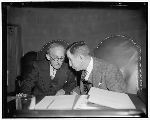 FCC whispers. Washington, D.C., Nov. 15. Pictured in this impromptu huddle are Federal Communications Chairman Frank McNinch, and Judge Eugene O. Sykes, who led in questioning today's witnesses at the FCC hearing into alleged monopolies in the radio industry