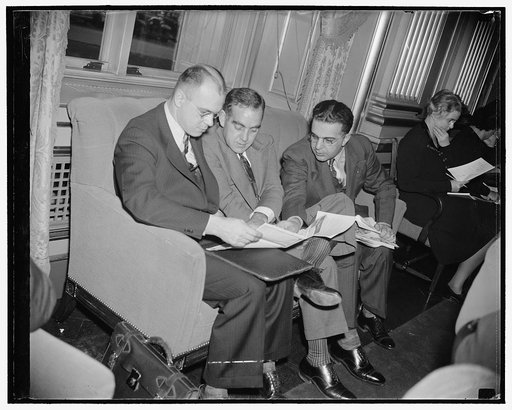 Lloyd J. Haney, President, St. Paul Typographical Union, representing Gov. elect Harold Stassen of Minnesota; E.C. Burris, Helena Montana; B.J. Dorsky, President of the Maine Federation of Labor, from Bangor; all going over a map of Washington with an eye to some sightseeing during breathing spells