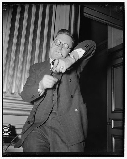 George L. Googe, Atlanta, Ga., southern representative of AF of L, making a long distance call to New Orleans and lighting a cigarette at the same time