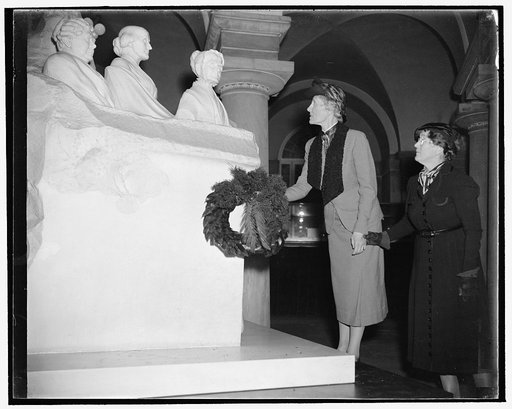 Royal Swedish feminist lays wreath at Capitol. Washington, D.C., Nov. 26, 1938. Baroness Ebba Nordenfelt, left, member of the recently organized World Women's Party, laying wreath before the Statue of the Equal Rights Pioneers located in the Capitol. The Baroness is here to make plans for Sweden's p