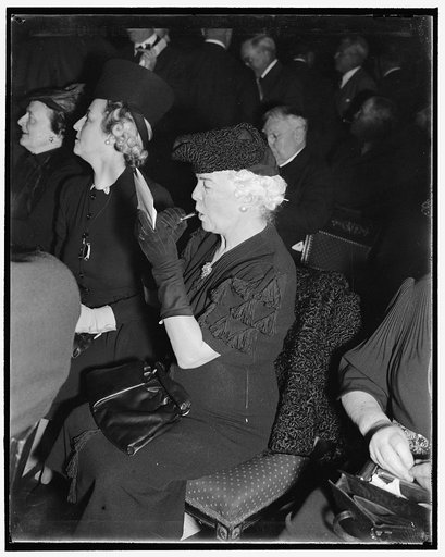 Beauty must be maintained even at Republican National Committee meeting. Washington, D.C., Nov. 29. That personal appearance must never be neglected--even at a meeting of the Republican National Committee--is evident in this picture of Mrs. Ralph A. Harris, National Committee-woman from Kansas, as s