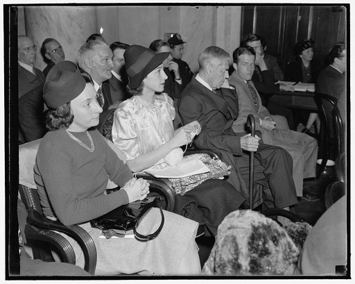 Knits and Listens. Washington, D.C., Dec. 2. Without dropping a stitch, Mrs. Leon Henderson, wife of the Secretary of the Monopoly Committee, nonchalantly continues her knitting as she listened to testimony at the Committee hearing today