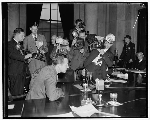 Cameramen 'shoot' Edsal [i.e. Edsel] Ford. Washington, D.C., Dec. 5. Edsal [i.e. Edsel] Ford, President of the Ford Motor Co., faced a battery of cameramen as he took the stand today before the Monopoly Committee. He told of early efforts of the Ford Motor Co. to maintain a patent monopoly, success 
