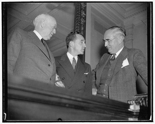 Off the record. Washington, D.C., Dec. 6. Following his appearance before the Senate Finance Subcommittee today, Edsal [i.e. Edsel] Ford chats informally with Chairman Clyde Herring, left, and Senator Arthur M. Vandenberg, Republican of Michigan