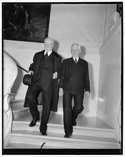 Chief Justice attends Red Cross meeting. Washington, D.C., Dec. 7. Chief Justice Charles Evans Hughes, Vice President, leaving a meeting of the Board of Incorporators of the American Red Cross today with Chairman Norman Davis. Davis was reappointed Chairman of the organization today by President Roo