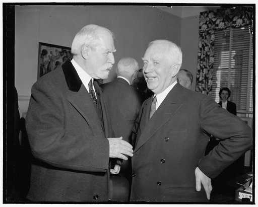 Discuss Red Cross problems. Washington, D.C., Dec. 7. Chief Justice Charles Evans Hughes, left, Vice President of the American Red Cross, discusses with Norman Davis, reappointed Chairman today, the problems facing the organization at the Annual Meeting of the Board of Incorporators