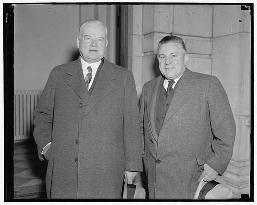 Ex-President Hoover arrives to attend meeting at Carnegie Institution. Washington, D.C., Dec. 9. Ex-President Herbert Hoover accompanied by his Secretary Lawrence Richey snapped as they arrived for the annual meeting of the Board of Trustees of the Carnegie Institution of Washington. Mr. Hoover is a