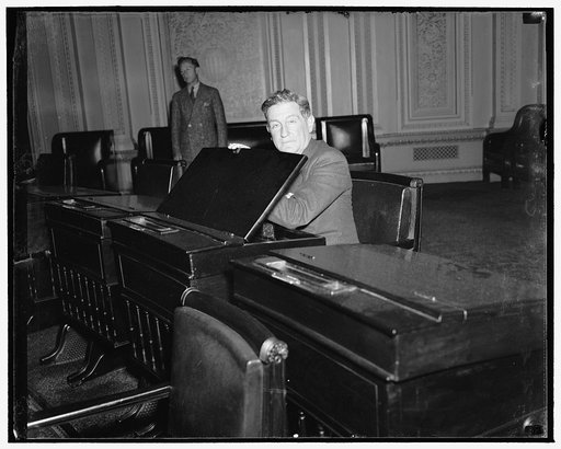 California Senator-elect gets 'feel' of desk in Senate chamber. Washington, D.C., Dec. 12. Senator-elect Sheridan Downey of California gets the 'feel' of the desk in the Senate chamber assigned to him today and which he will occupy when congress convenes on January 3. Downey succeeds William Gibbs M