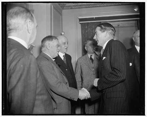 Ickes greets Eden. Washington, D.C., Dec. 13. Arriving at the National Press Club luncheon today, Anthony Eden, former British Foreign Secretary, is greeted by Secretary of the Interior Harold Ickes. Also in the picture is undersecretary of State R. Walton Moore, 12/13/38